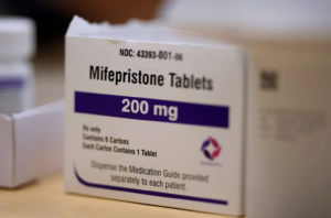 Photograph of a white box with black letters that reads Mifepristone tablets