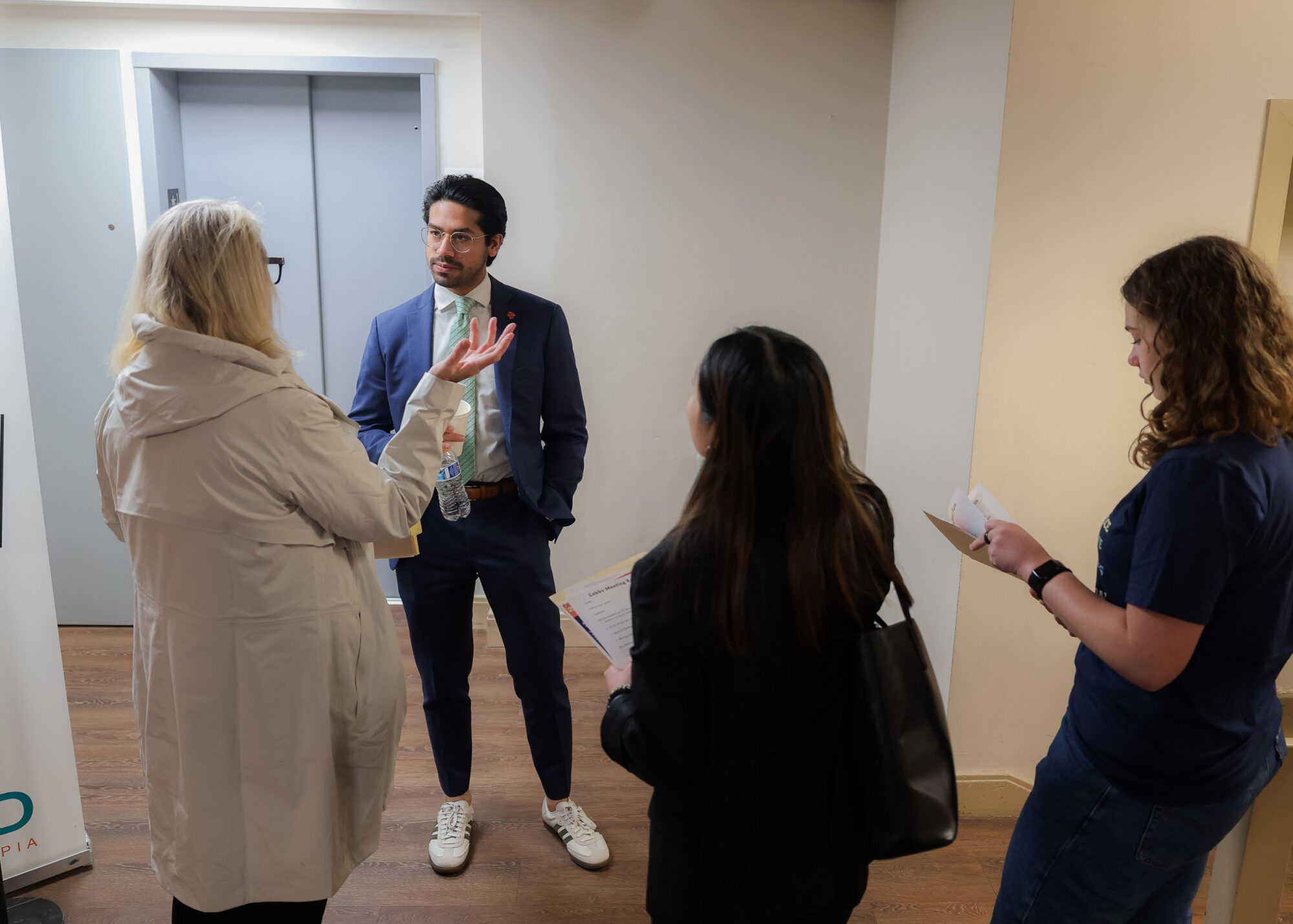 Activists speak with their representative in a hallway