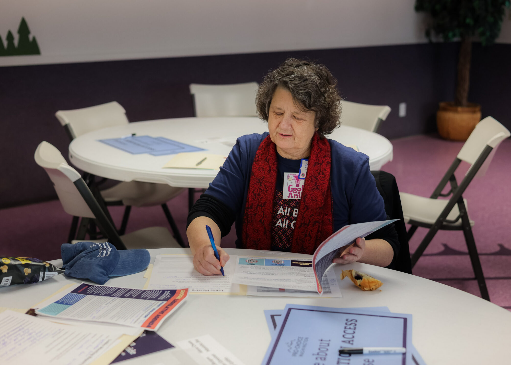 An activist sits at a round table, reading papers